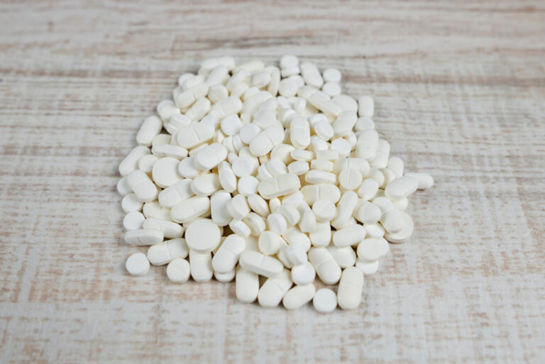 pile pills wooden background view from