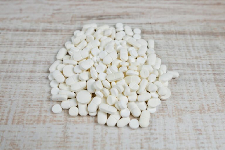 pile pills wooden background view from
